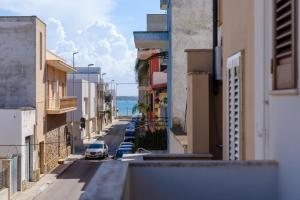 a view of a city street with cars parked on the street at Affaccio Sul Mare Luxury Home in Porto Cesareo