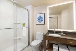 a bathroom with a shower and a toilet and a sink at Candlewood Suites Boise-Meridian, an IHG Hotel in Meridian