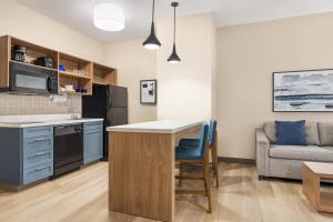 a kitchen with a counter and a table and a couch at Candlewood Suites Boise-Meridian, an IHG Hotel in Meridian