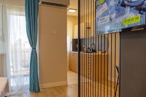 a living room with a flat screen tv and a living room at JAZZ 2 apartman in Brčko