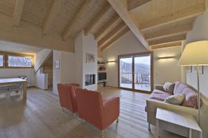 a living room with a couch and a table at Chesa Piz Chalchagn - Pontresina in Pontresina