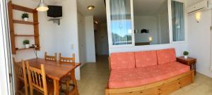 a living room with a couch and a table at Trill Mirasol E estudio 1a linea mar in L'Estartit