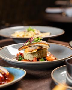 a plate of food with a sandwich on a table at Derwent Manor Boutique Hotel in Consett