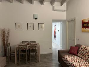 a living room with a table and a couch at AM's Apartment in La Spezia