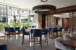a restaurant with tables and chairs and windows at The Westin Reston Heights in Reston