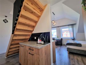 a staircase leading up to a room with a bedroom at Willa Sky in Jastrzębia Góra
