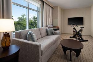 a living room with a couch and a large window at The Westin Reston Heights in Reston