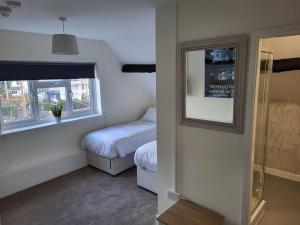a small bedroom with a bed and a window at The Bird in Hand in Stourport