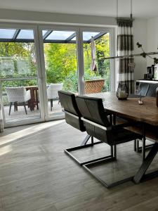 a dining room with a wooden table and chairs at Ferienwohnung am Bach 