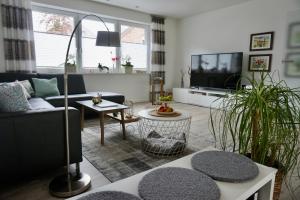 a living room with a couch and a tv at Ferienwohnung am Bach 