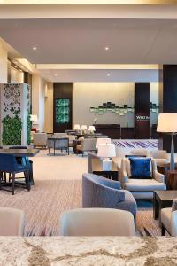 a hotel lobby with couches and tables and chairs at The Westin Edina Galleria in Edina