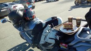 a motorcycle with a plate of cake and drinks on it at ciao-aschau Haus zur Burg Apn220 Mina in Aschau