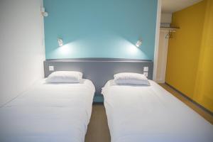 Postel nebo postele na pokoji v ubytování Kyriad Direct Nancy Sud -Vandoeuvre - Rénové