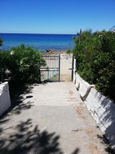 a gate to a beach with the ocean in the background at CAMPING MADDALENA in Palinuro