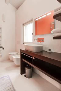 a bathroom with a sink and a mirror at Vicolo Zini Apartments in Verona