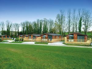 a row of wooden cabins in a park at Robin Lodge in Skipton