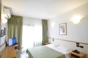 Postel nebo postele na pokoji v ubytování Hotel degli Ulivi