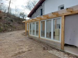 an extension to a house with sliding glass doors at Gite de Moulin Maurt 1 in Xertigny