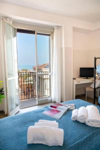 a room with a bed with a view of the ocean at Hotel Selene - Vista Mare in Riccione