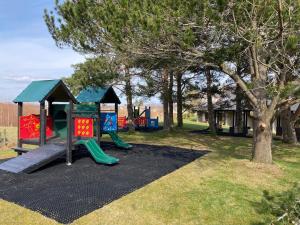 a park with a playground with a slide at Scandinavian Village Ltd in Aviemore
