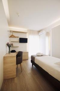 A bed or beds in a room at Hotel Olivò