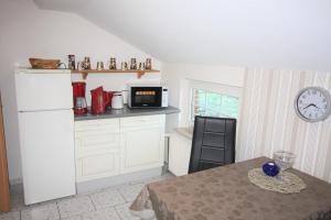 a kitchen with a table and a microwave at Kleinheide 1 in Berumbur