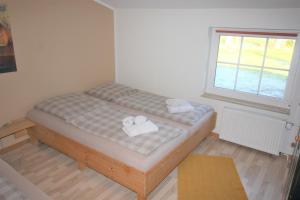 a small bedroom with a bed with towels on it at Kleinheide 1 in Berumbur