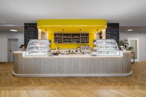 a restaurant with a counter with a yellow background at Hotel Restovna in Jíloviště