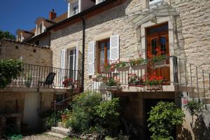 a stone house with flower boxes on its windows at Les Gagères in Puligny-Montrachet