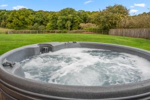 a hot tub in the middle of a yard at Lodge Barn in Lydney