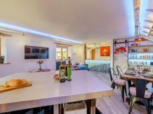 a kitchen and living room with a table and chairs at The Artist Studio in Hest Bank