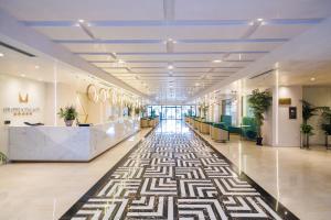 an empty lobby with a patterned floor in a building at Gloria Palace Hotel & SPA in Golem