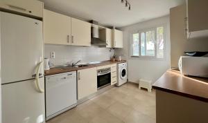 a kitchen with a white refrigerator and a dishwasher at Apartment in Hacienda Riquelme Golf Resort in Sucina