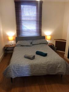 a bedroom with a bed with two pillows on it at The Brougham House in Bath