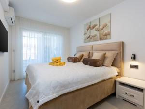 a bedroom with a bed with a teddy bear on it at Residence Nar in Poreč