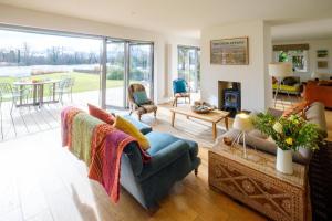 a living room with a couch and a table at Lowlands in Thorpeness