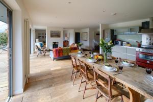 a kitchen and living room with a table and chairs at Lowlands in Thorpeness