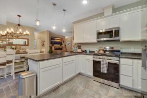 a kitchen with white cabinets and a stove top oven at Lazy Bear Inn in Boyne City