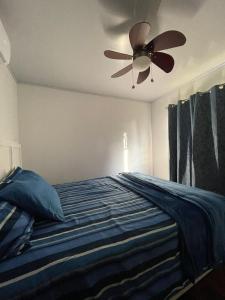 um quarto com uma cama e uma ventoinha de tecto em Casa Lapa Delicias em Montezuma