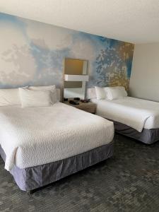 a hotel room with two beds and a mural at Courtyard Boston Raynham in Raynham