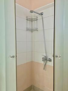 a shower with a glass door in a bathroom at Feels like home (Vari) in Vari +27 photos