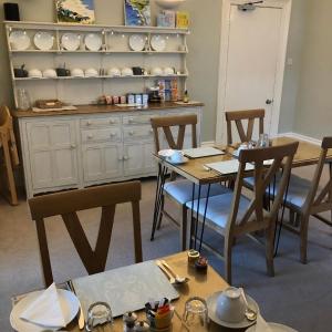 a kitchen with a table and chairs and a counter at Hotel 50 in Bournemouth