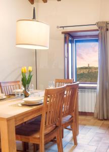 a dining room with a table and a window at La Finestra su Civita in Lubriano