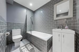 a bathroom with a toilet and a sink and a mirror at Majestic 4 at Reganway RW4 in London