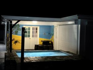 - une vue nocturne sur la piscine dans une maison dans l'établissement VillaCalmflor, à Sainte-Anne