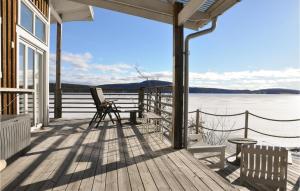 a porch of a house with a view of the water at Stunning Home In motfors With Lake View in Åmotsfors