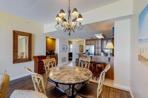 a dining room and kitchen with a table and chairs at Spanish Key 304 in Perdido Key