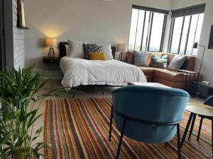 a living room with a bed and a couch at Apartment 4023-stunning views in Sandton in Johannesburg