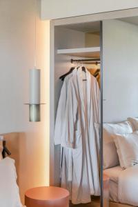 a closet with a robe hanging in a bedroom at The Views Baia - Adults Only in Funchal