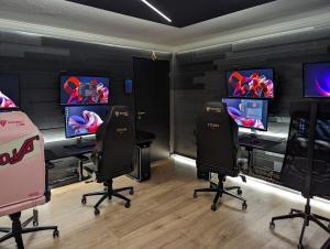 a video game room with four chairs and consoles at Smart Luxury - Gaming Arena, Gym, Sauna and Jacuzzi in Keflavík
